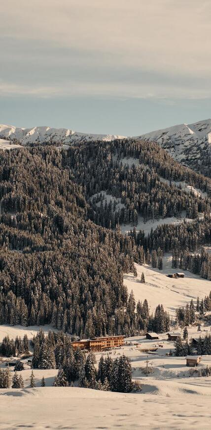 Hotel Floralpina on Alpe di Siusi surrounded by snow-covered meadows, forests and Dolomite peaks