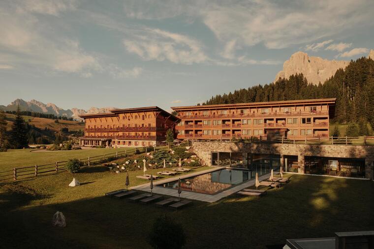 Exterior view of Sporthotel Floralpina on the Seiser Alm with outdoor pool and Dolomites view