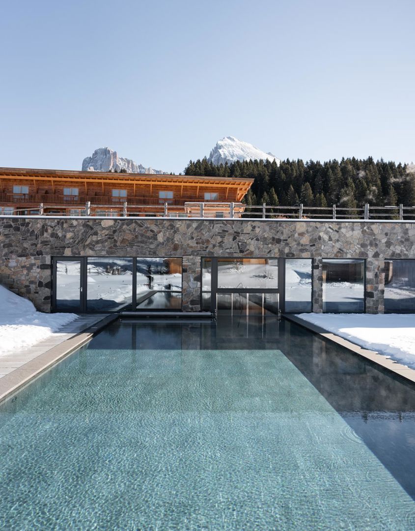 Our hotel with outdoor pool on the Seiser Alm in winter