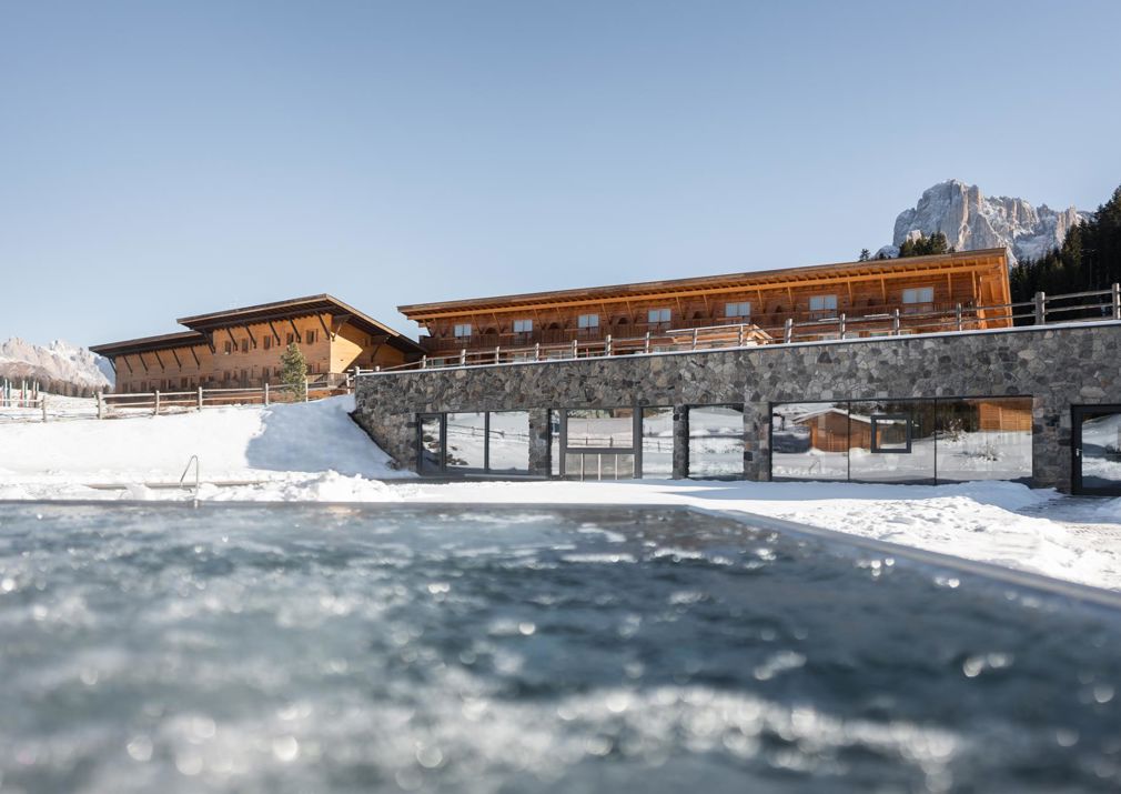 Our hotel with outdoor pool on the Seiser Alm in winter