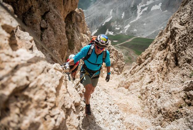 Climber ascending a via ferrata route in the Dolomites near Alpe di Siusi Seiser Alm