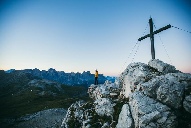 Hiking on the Seiser Alm: a man at the peak of a mountain